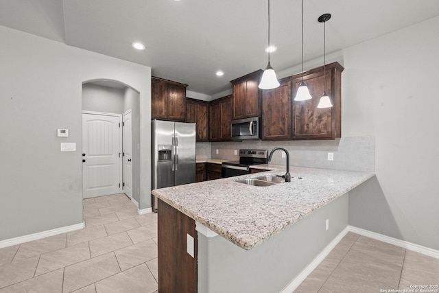 546 Indian Scout, Spring Branch, TX 78070 - kitchen with stainless steel appliances, a sink, arched walkways, backsplash, and dark brown cabinets
