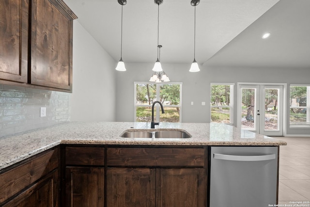 546 Indian Scout, Spring Branch, TX 78070 - kitchen with stainless steel dishwasher, a sink, vaulted ceiling, decorative backsplash, and light tile patterned floors