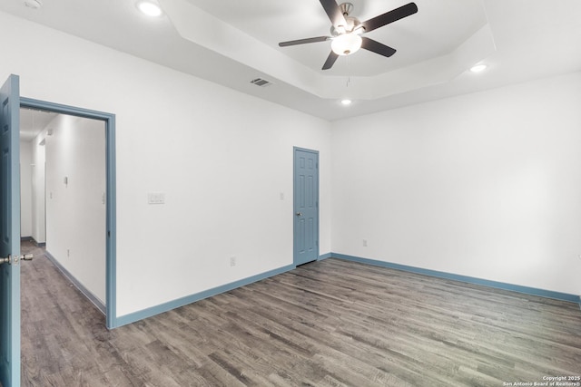241 Hawthorne, San Antonio, TX 78214 - spare room with recessed lighting, wood finished floors, a ceiling fan, a tray ceiling, and baseboards