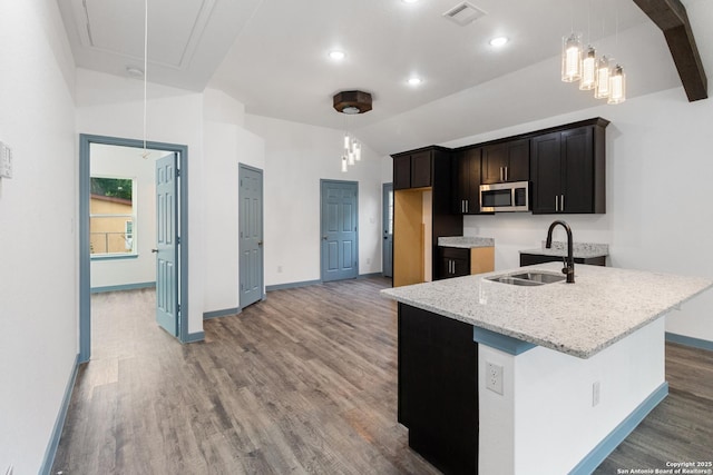 241 Hawthorne, San Antonio, TX 78214 - kitchen featuring stainless steel microwave, a sink, wood finished floors, baseboards, and light stone counters