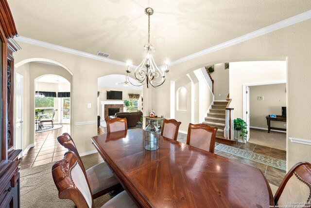3353 Joshs Way, Marion, TX 78124 - dining space featuring tile patterned flooring, arched walkways, stairway, crown molding, and a chandelier