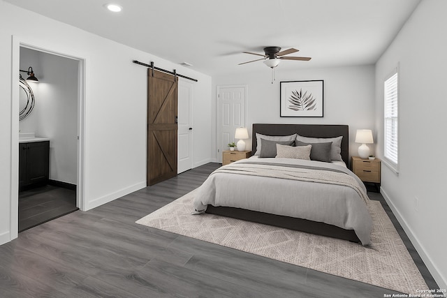 7630 Sage Oak St, Live Oak, TX 78233 - bedroom featuring a barn door, baseboards, dark wood finished floors, recessed lighting, and ceiling fan