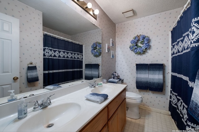 5626 Timber Strm, San Antonio, TX 78250 - bathroom with wallpapered walls, double vanity, toilet, a textured ceiling, and tile patterned floors