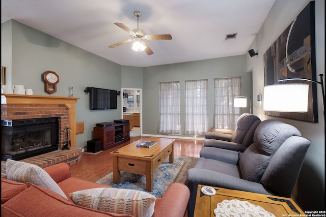 5626 Timber Strm, San Antonio, TX 78250 - living area featuring wood finished floors, a fireplace, and ceiling fan