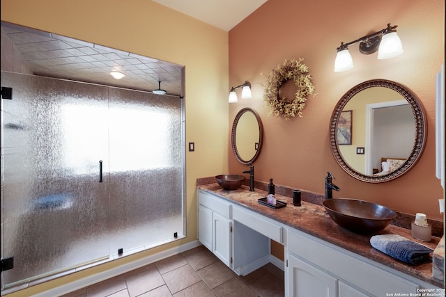 5626 Timber Strm, San Antonio, TX 78250 - bathroom with a stall shower, double vanity, and tile patterned flooring