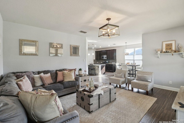 5903 Carriage Cpe, San Antonio, TX 78261 - living room with a chandelier, baseboards, and wood finished floors