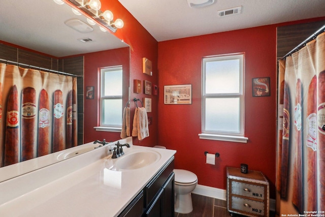 5903 Carriage Cpe, San Antonio, TX 78261 - bathroom with vanity, toilet, baseboards, wood finished floors, and curtained shower