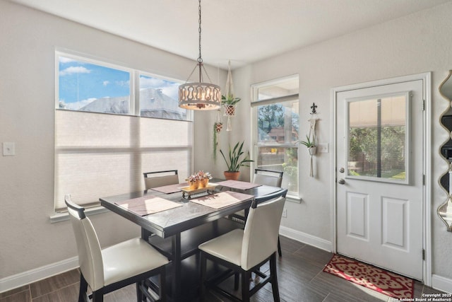 5903 Carriage Cpe, San Antonio, TX 78261 - dining space featuring a chandelier, baseboards, dark wood-type flooring, and plenty of natural light