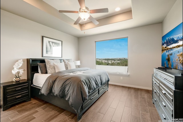 23414 Seven Winds, San Antonio, TX 78258 - bedroom with a tray ceiling, wood finished floors, baseboards, and ceiling fan