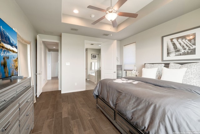 23414 Seven Winds, San Antonio, TX 78258 - bedroom with a raised ceiling, dark wood-type flooring, recessed lighting, baseboards, and connected bathroom