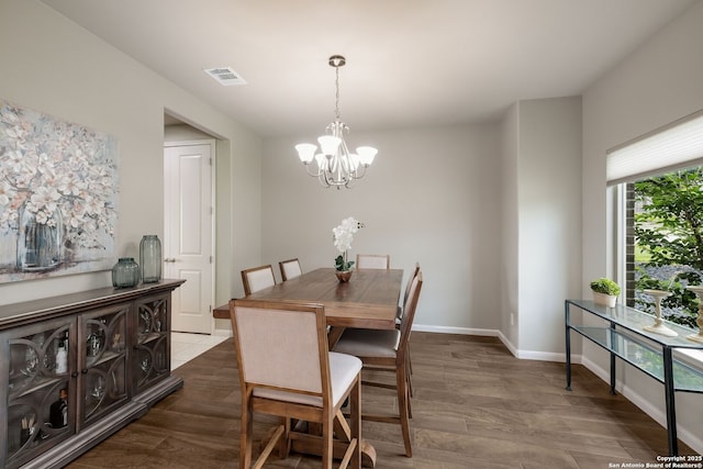 23414 Seven Winds, San Antonio, TX 78258 - dining room with a chandelier, dark wood-style flooring, and baseboards