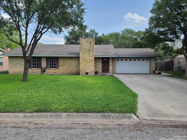 117 Larkspur, Uvalde, TX 78801 - ranch-style house with a chimney, brick siding, driveway, and a garage