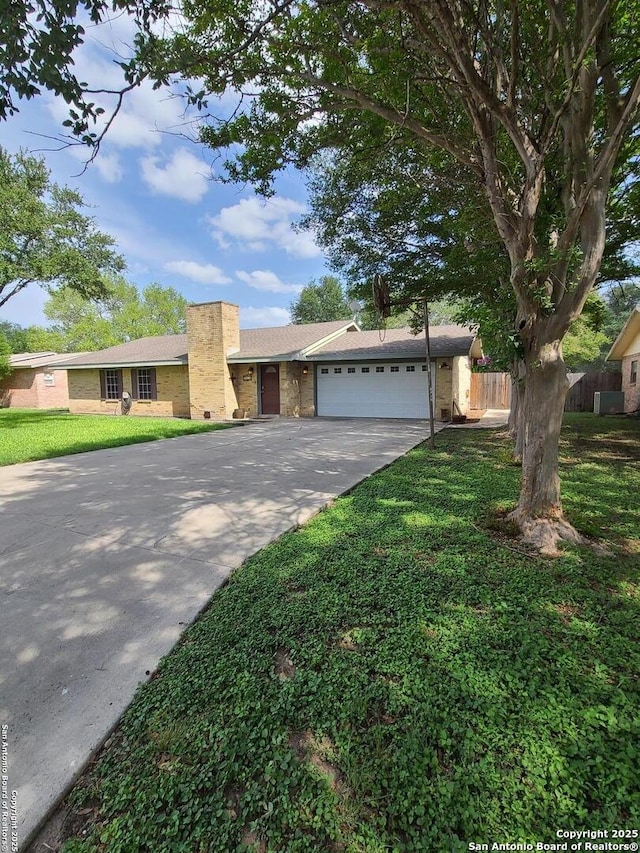117 Larkspur, Uvalde, TX 78801 - single story home with driveway, a garage, and a chimney