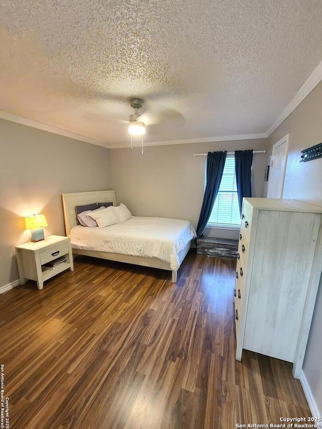 117 Larkspur, Uvalde, TX 78801 - bedroom with a textured ceiling, ornamental molding, dark wood finished floors, a ceiling fan, and baseboards