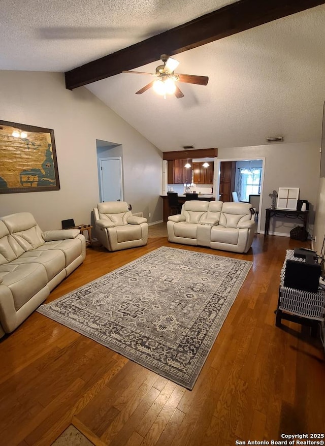 117 Larkspur, Uvalde, TX 78801 - living area with a ceiling fan, a textured ceiling, dark wood-style flooring, and baseboards