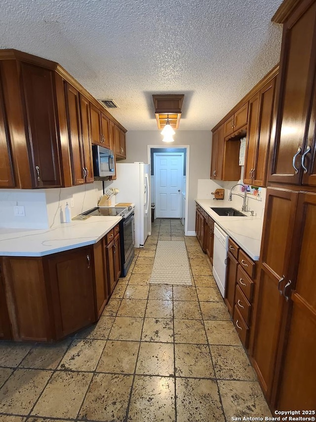 117 Larkspur, Uvalde, TX 78801 - kitchen featuring stainless steel microwave, electric range, dishwasher, light countertops, and a sink