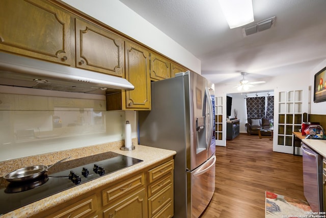 713 Fawndale, Windcrest, TX 78239 - kitchen featuring stainless steel appliances, under cabinet range hood, light countertops, a ceiling fan, and wood finished floors