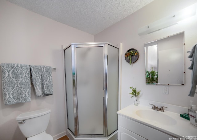 713 Fawndale, Windcrest, TX 78239 - bathroom with vanity, a textured ceiling, toilet, and a stall shower