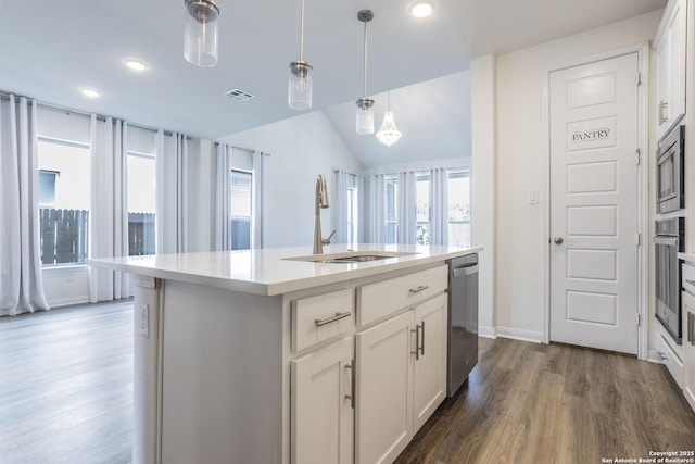 8639 Hedford, San Antonio, TX 78254 - kitchen featuring appliances with stainless steel finishes, a sink, dark wood finished floors, light countertops, and white cabinetry