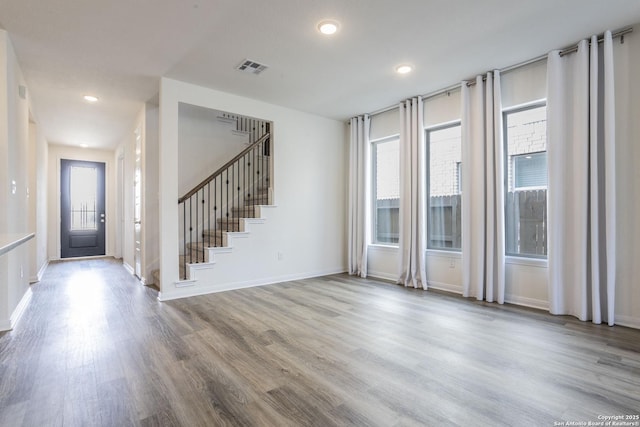 8639 Hedford, San Antonio, TX 78254 - foyer featuring healthy amount of natural light, wood finished floors, stairway, baseboards, and recessed lighting