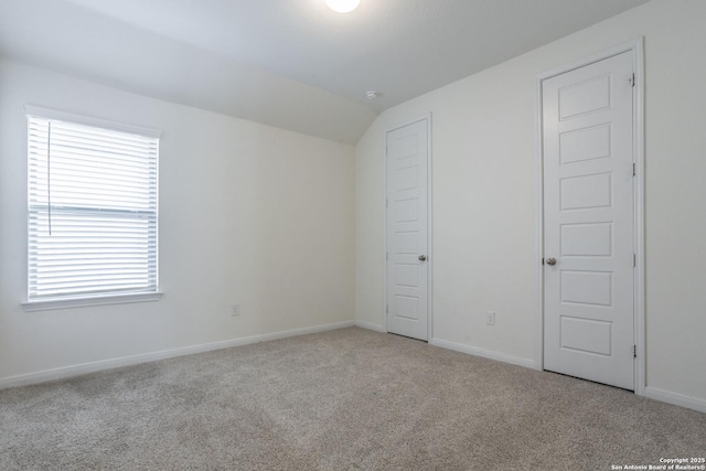 8639 Hedford, San Antonio, TX 78254 - unfurnished bedroom featuring light carpet, vaulted ceiling, and baseboards