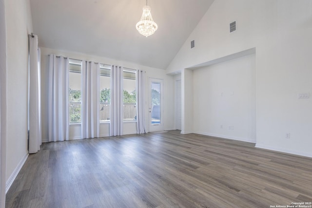 8639 Hedford, San Antonio, TX 78254 - empty room with a chandelier, high vaulted ceiling, wood finished floors, and baseboards
