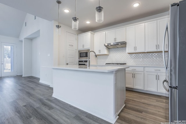 8639 Hedford, San Antonio, TX 78254 - kitchen featuring appliances with stainless steel finishes, under cabinet range hood, tasteful backsplash, white cabinets, and recessed lighting