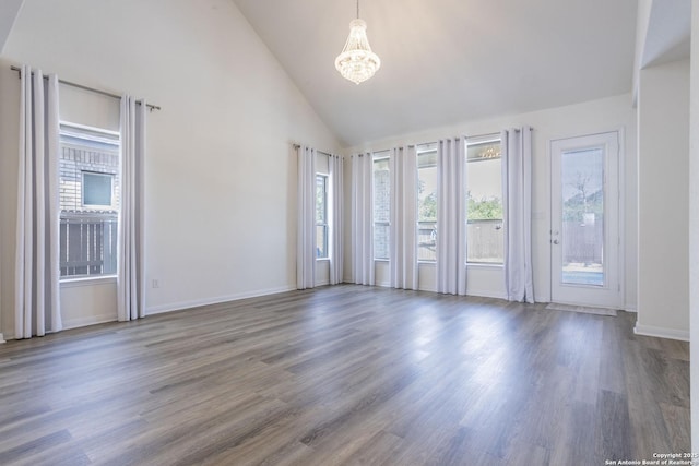 8639 Hedford, San Antonio, TX 78254 - unfurnished room with a chandelier, plenty of natural light, high vaulted ceiling, wood finished floors, and baseboards