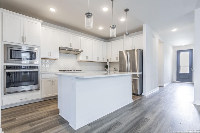 8639 Hedford, San Antonio, TX 78254 - kitchen featuring appliances with stainless steel finishes, under cabinet range hood, backsplash, light countertops, and recessed lighting