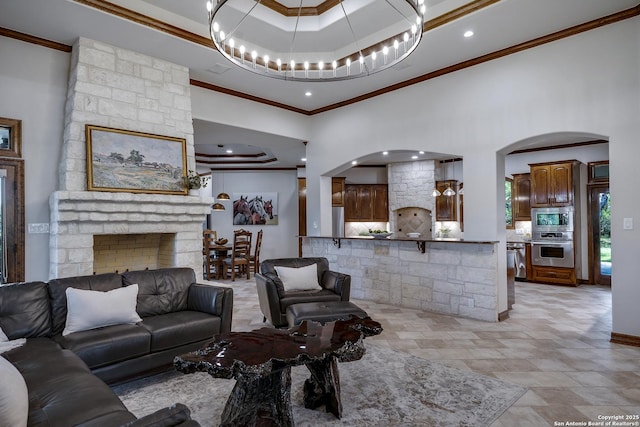 112 Legend Holw, Boerne, TX 78006 - living room with arched walkways, crown molding, a tray ceiling, a towering ceiling, and recessed lighting