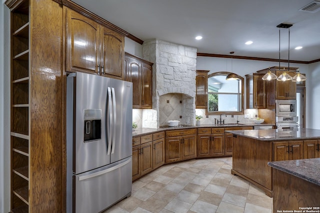 112 Legend Holw, Boerne, TX 78006 - kitchen with appliances with stainless steel finishes, ornamental molding, decorative backsplash, a sink, and dark stone countertops