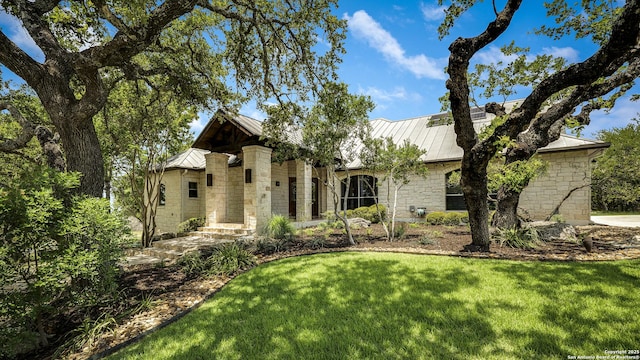 112 Legend Holw, Boerne, TX 78006 - view of front of house with stone siding, a standing seam roof, and a front lawn