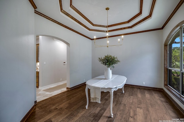 112 Legend Holw, Boerne, TX 78006 - dining space featuring arched walkways, a raised ceiling, crown molding, light wood-style floors, and baseboards