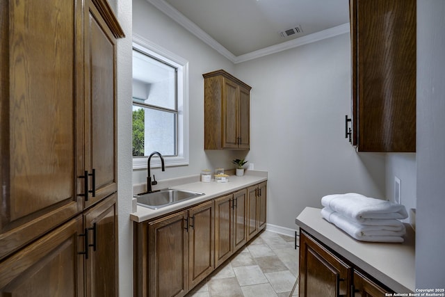 112 Legend Holw, Boerne, TX 78006 - kitchen with a sink, ornamental molding, light countertops, and baseboards
