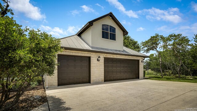 112 Legend Holw, Boerne, TX 78006 - view of property exterior featuring a standing seam roof, metal roof, driveway, a garage, and stucco siding