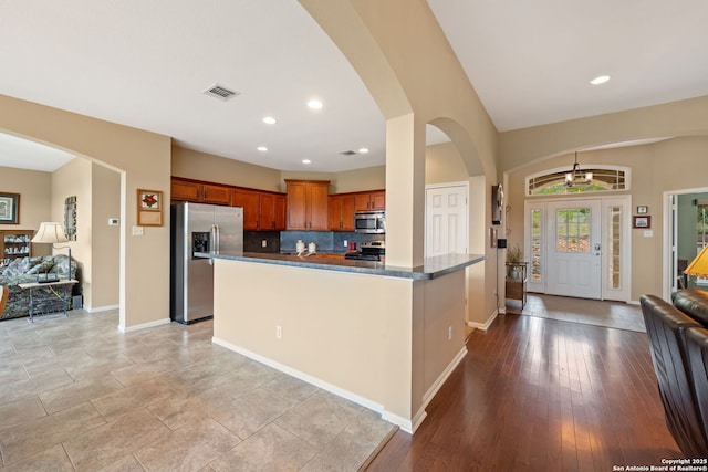 212 Vista Vw, Spring Branch, TX 78070 - kitchen featuring stainless steel appliances, open floor plan, dark countertops, baseboards, and decorative backsplash