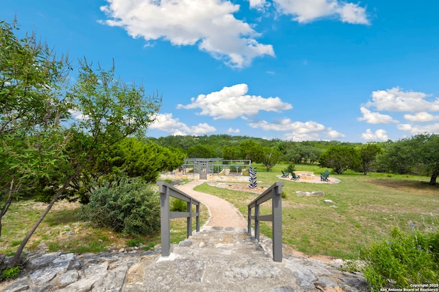 212 Vista Vw, Spring Branch, TX 78070 - view of green lawn featuring an outdoor fire pit and a forest view