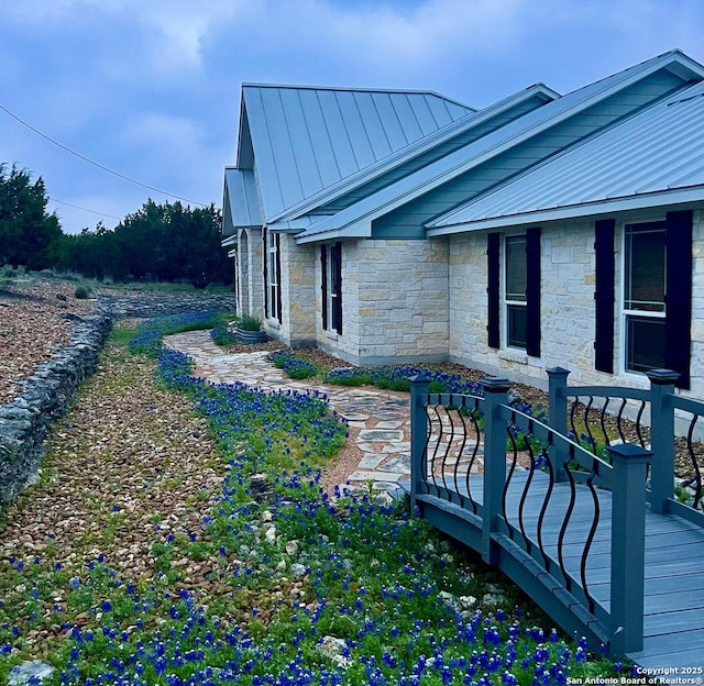 212 Vista Vw, Spring Branch, TX 78070 - view of side of property featuring a standing seam roof, stone siding, and metal roof