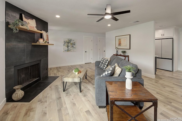 2714 Floral Way, San Antonio, TX 78247 - living room with a large fireplace, light wood-style flooring, a ceiling fan, and recessed lighting