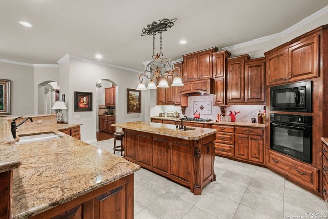 20027 Buckhead, Garden Ridge, TX 78266 - kitchen featuring black appliances, arched walkways, a sink, a center island with sink, and backsplash
