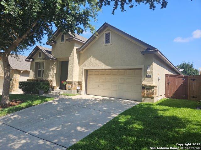 3607 Tea Rose Gln, San Antonio, TX 78259 - view of front of home featuring an attached garage, stucco siding, and driveway