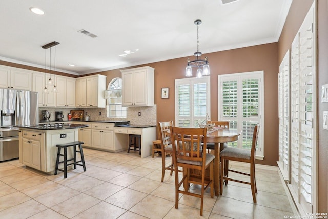 2929 Mccaskey Rdg, San Antonio, TX 78258 - kitchen with stainless steel refrigerator with ice dispenser, backsplash, dark countertops, a chandelier, and crown molding