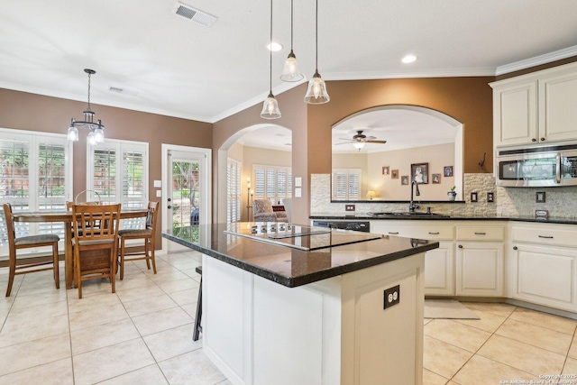 2929 Mccaskey Rdg, San Antonio, TX 78258 - kitchen with a sink, stainless steel microwave, black electric cooktop, light tile patterned floors, and a ceiling fan