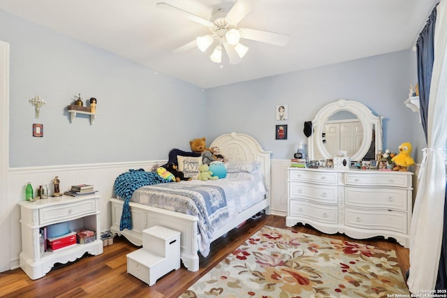 2929 Mccaskey Rdg, San Antonio, TX 78258 - bedroom with wainscoting, wood finished floors, and a ceiling fan