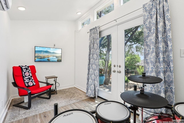 2929 Mccaskey Rdg, San Antonio, TX 78258 - sitting room with wood finished floors, a wall mounted air conditioner, french doors, baseboards, and recessed lighting