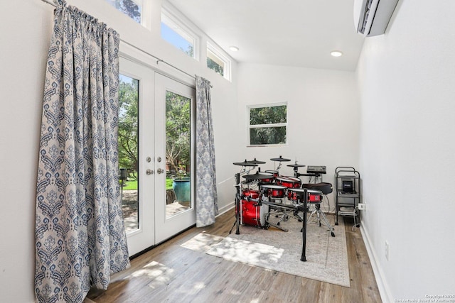 2929 Mccaskey Rdg, San Antonio, TX 78258 - recreation room featuring french doors, wood finished floors, a wall mounted AC, baseboards, and recessed lighting