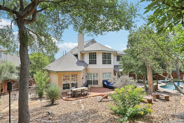 2929 Mccaskey Rdg, San Antonio, TX 78258 - back of property featuring a shingled roof, a chimney, stucco siding, and a wooden deck