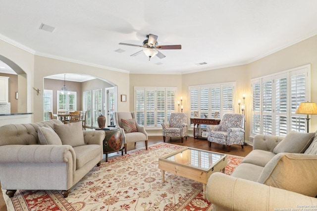 2929 Mccaskey Rdg, San Antonio, TX 78258 - living area with arched walkways, a ceiling fan, plenty of natural light, wood finished floors, and crown molding