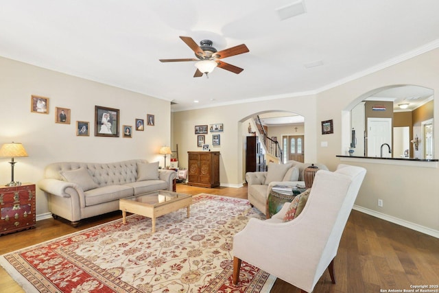 2929 Mccaskey Rdg, San Antonio, TX 78258 - living area featuring arched walkways, a ceiling fan, crown molding, wood finished floors, and baseboards