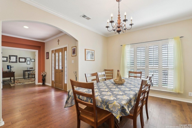 2929 Mccaskey Rdg, San Antonio, TX 78258 - dining area featuring arched walkways, a chandelier, hardwood / wood-style flooring, baseboards, and ornamental molding